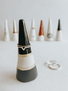 Store and display your favourite rings with this Black and Gold ring cone. It's such a beautiful addition to your space, adding a touch magic! Made with air dry clay, painted with black and gold acrylic paint and sealed with a high gloss coating to make it water resistant.
