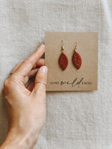 Handmade burnt terracotta polymer clay dangle leaf earrings with gold nickel free jewellery components.