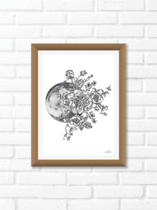 Black and white illustration of a Moon surrounded by botanicals. Pair your prints with other illustrations to create a whimsical story of your own.