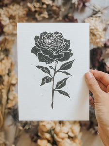The process starts with a paper drawing that is then transferred to a Lino sheet and carefully hand carved by me, using special tools. Once the carving work is done, a water-based ink is rolled onto the print and then printed onto a sheet of paper. The outcome is rather charming! This elegant rose print can be framed, pegged to a line/meshboard, used in journaling or sent as a gift to a friend. 
