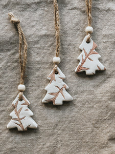 Handmade using air dry clay and painted with a soft neutral brown, these Christmas trees can be used in multiple ways. Hang them on your tree for a earthy, nature-inspired boho Christmas look. Use them as tags for gifts to friends and loved ones. Use them as table setting decor.