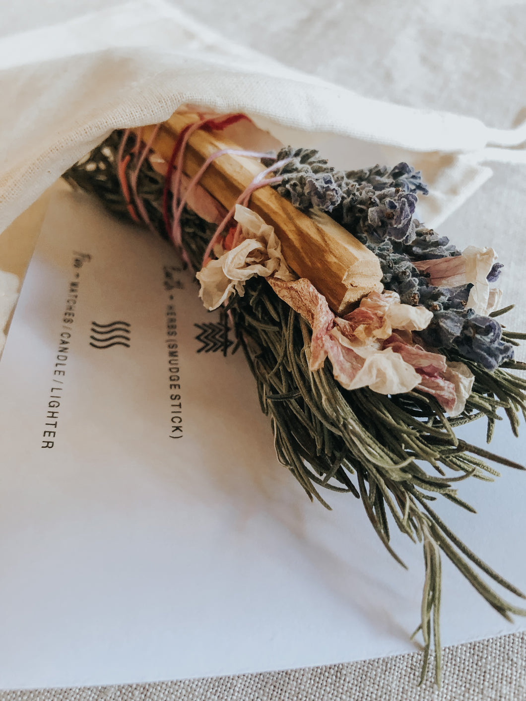 Floral smudge stick with rosemary, hibiscus, lavender, palo santo and a small rose quartz crystal. Great for cleaning negative energy and inviting positivity, love, protection and creativity into your space.