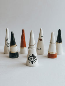 Store and display your favourite rings with this Sienna Base ring cone. It's such a beautiful addition to your space, adding a touch boho magic! Made with air dry clay, painted with sienna and gold acrylic paint and sealed with a high gloss coating to make it water resistant.