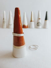 Store and display your favourite rings with this Sienna Tip ring cone. It's such a beautiful addition to your space, adding a touch magic! Made with air dry clay, painted with sienna and gold acrylic paint and sealed with a high gloss coating to make it water resistant.