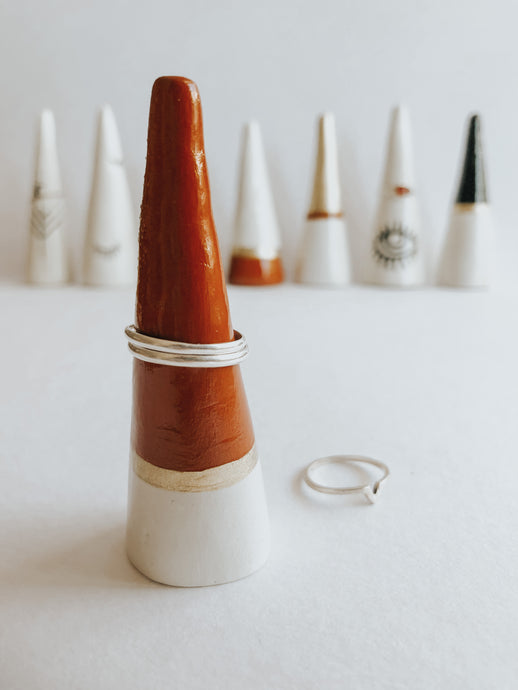 Store and display your favourite rings with this Sienna Tip ring cone. It's such a beautiful addition to your space, adding a touch magic! Made with air dry clay, painted with sienna and gold acrylic paint and sealed with a high gloss coating to make it water resistant.