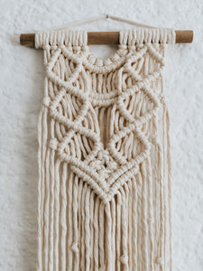 Made using soft single twist cotton rope on a wooden dowel, this wall hanging is narrow with a long tail, perfect for small areas needing a touch of love.