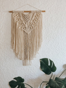 Sakari meaning "sweet" is just that! A sweet and charming little wall hanging made with 3mm 3-ply cotton rope on a wooden dowel rod. She was made with the intention of inviting sweetness into your day with details of button knots along with her elegant layered design. 