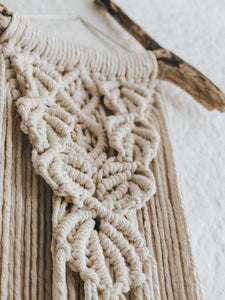 The perfect bohemian addition to an entrance hallway, a bedroom or office. Made using single twist cotton rope on a beautiful and interesting treated piece of driftwood foraged in Cape Town. Eye catching and elegant!