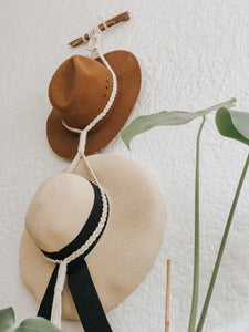 We all have a favourite hat (or two...) but nowhere to store them, so hang them in style when they're not in use with this chic boho macrame hat hanger. It's decor and practicality all in one! Made on driftwood.