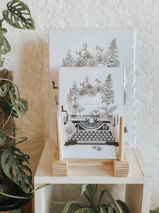 Black and white illustration of a typewriter surrounded with botanicals. Simply download, print, frame and enjoy!