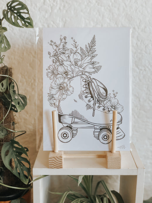 Black and white illustration of roller skates surrounded with botanicals. Pair your prints with other illustrations to create a whimsical story of your own.