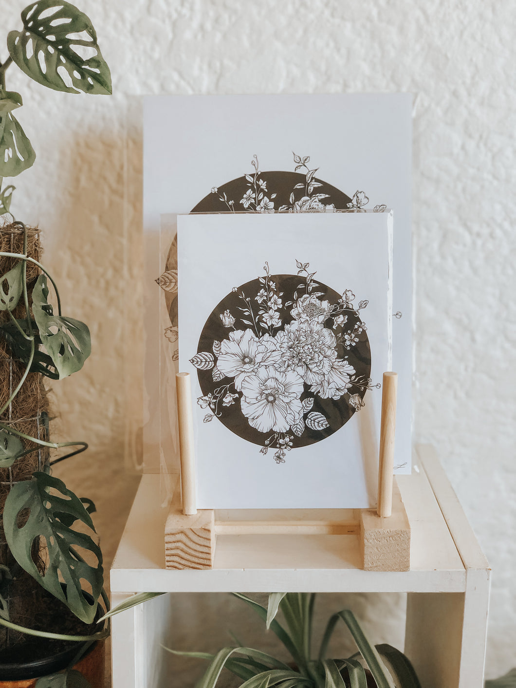 Black and white illustration of botanicals within a black void background. Pair your prints with other illustrations to create a whimsical story of your own.