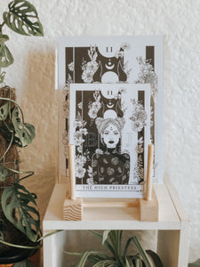 Black and white illustration of The High Priestess Tarot Card surrounded with botanicals. Pair your prints with other illustrations to create a whimsical story of your own.